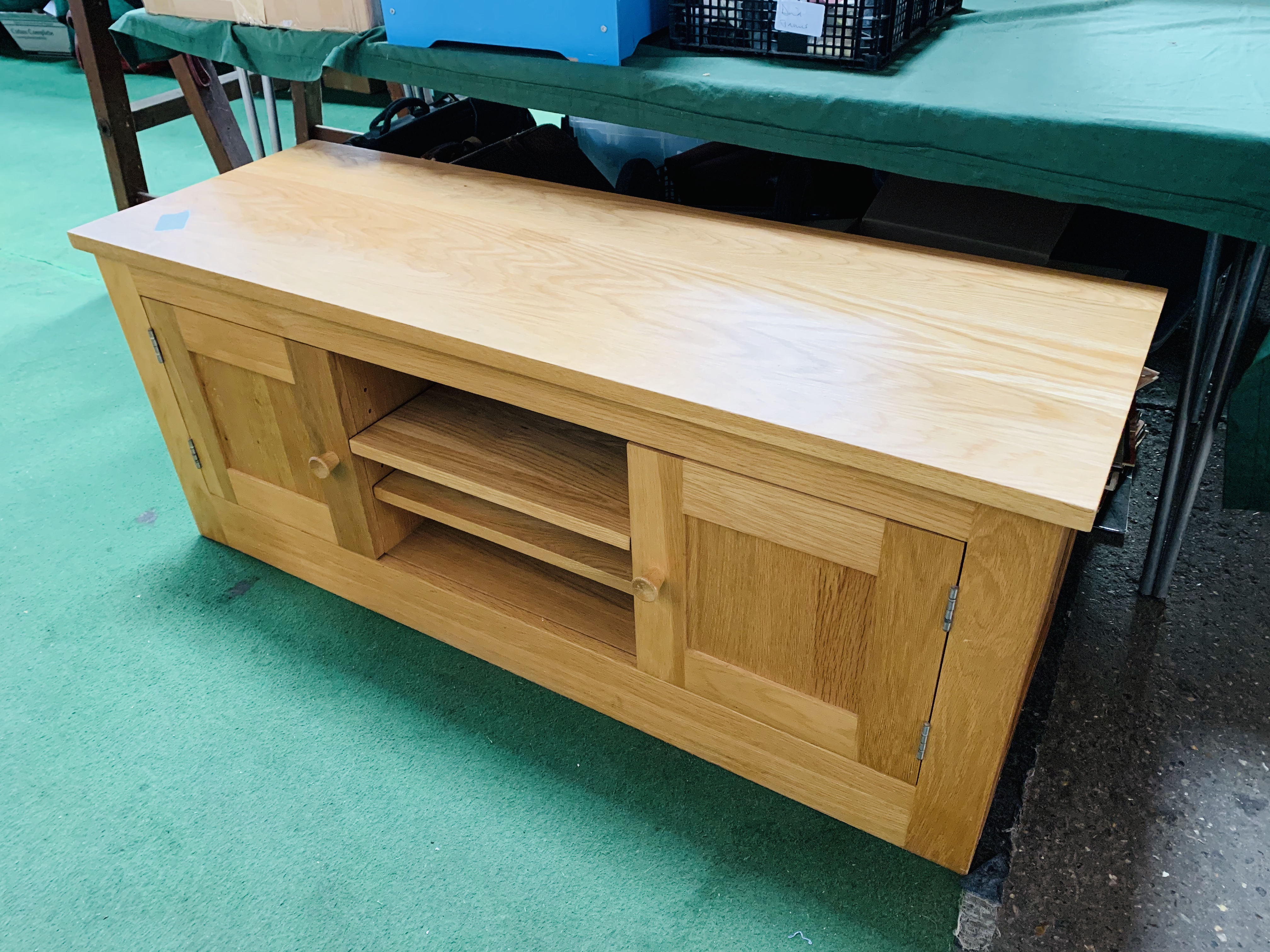 Oak veneered low sideboard with two cupboards and central shelves.