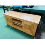 Oak veneered low sideboard with two cupboards and central shelves.