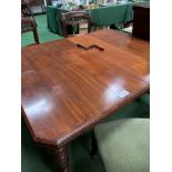 Mahogany wind out dining table with 2 leaves, on casters.