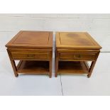 A pair of Chinese hardwood lamp tables with frieze drawer and display shelf.
