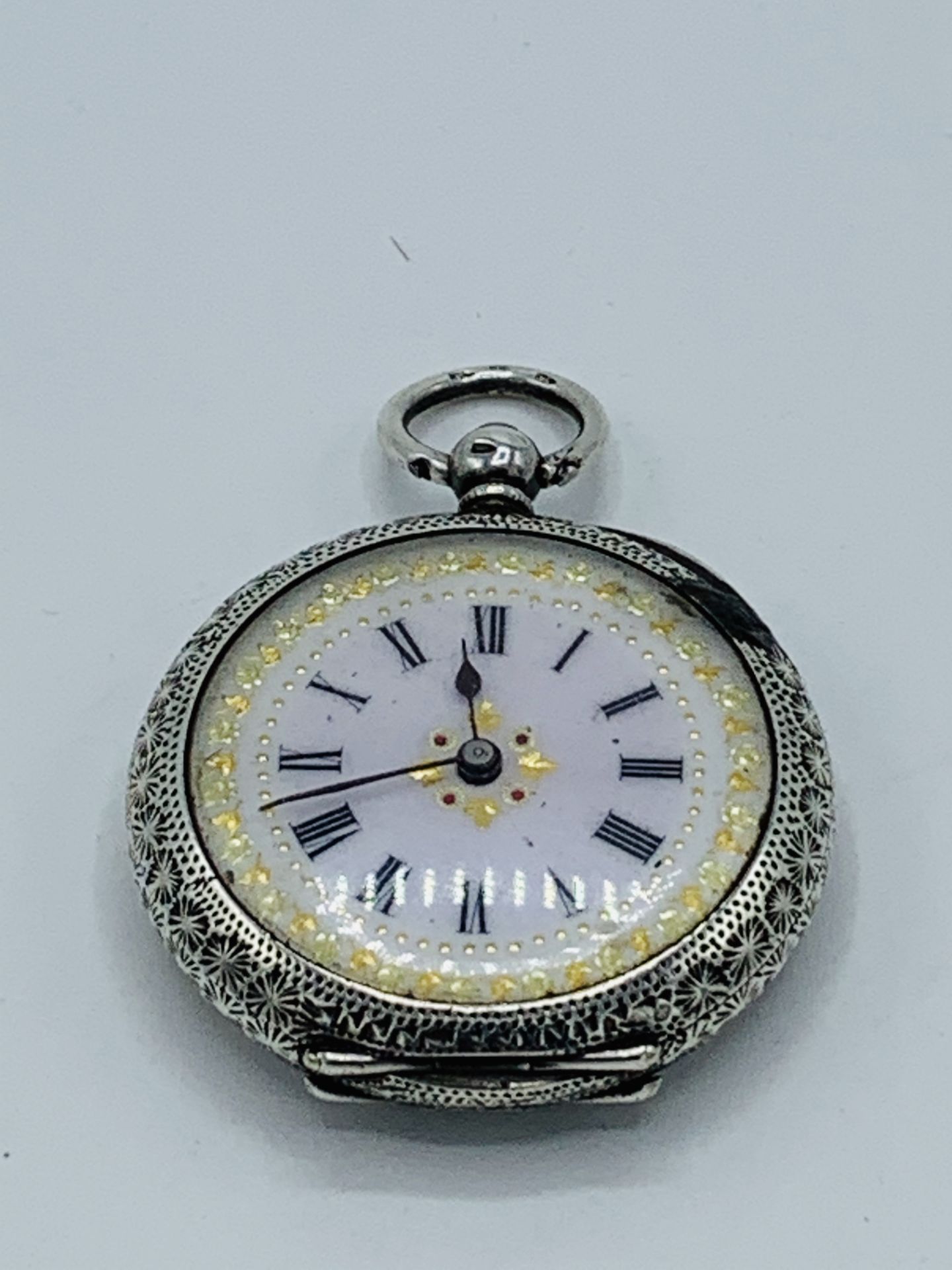 Lady's fob watch hallmarked 935, with white enamel face, and winding key.