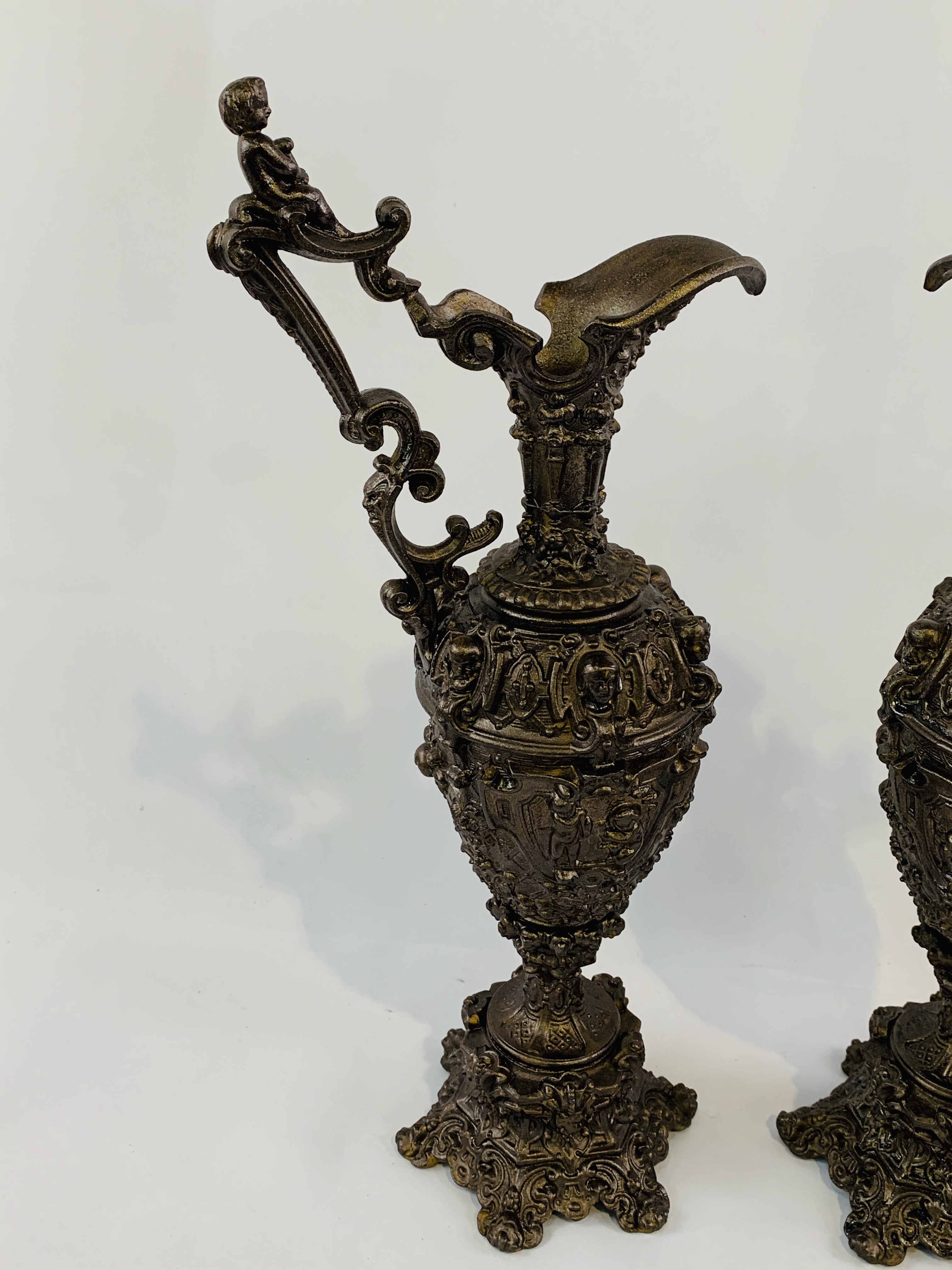 Pair of large Grecian ewers, bronzed and ornately cast with cherub handles. - Image 2 of 3