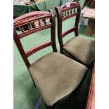 Four mahogany dining chairs with green upholstered seats.