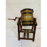 A vintage 'Lister' manual butterchurn on stand.