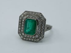 Large emerald and diamond platinum ring.