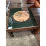 Brass top wooden coffee table showing 1630 map of the world.