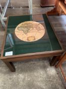 Brass top wooden coffee table showing 1630 map of the world.