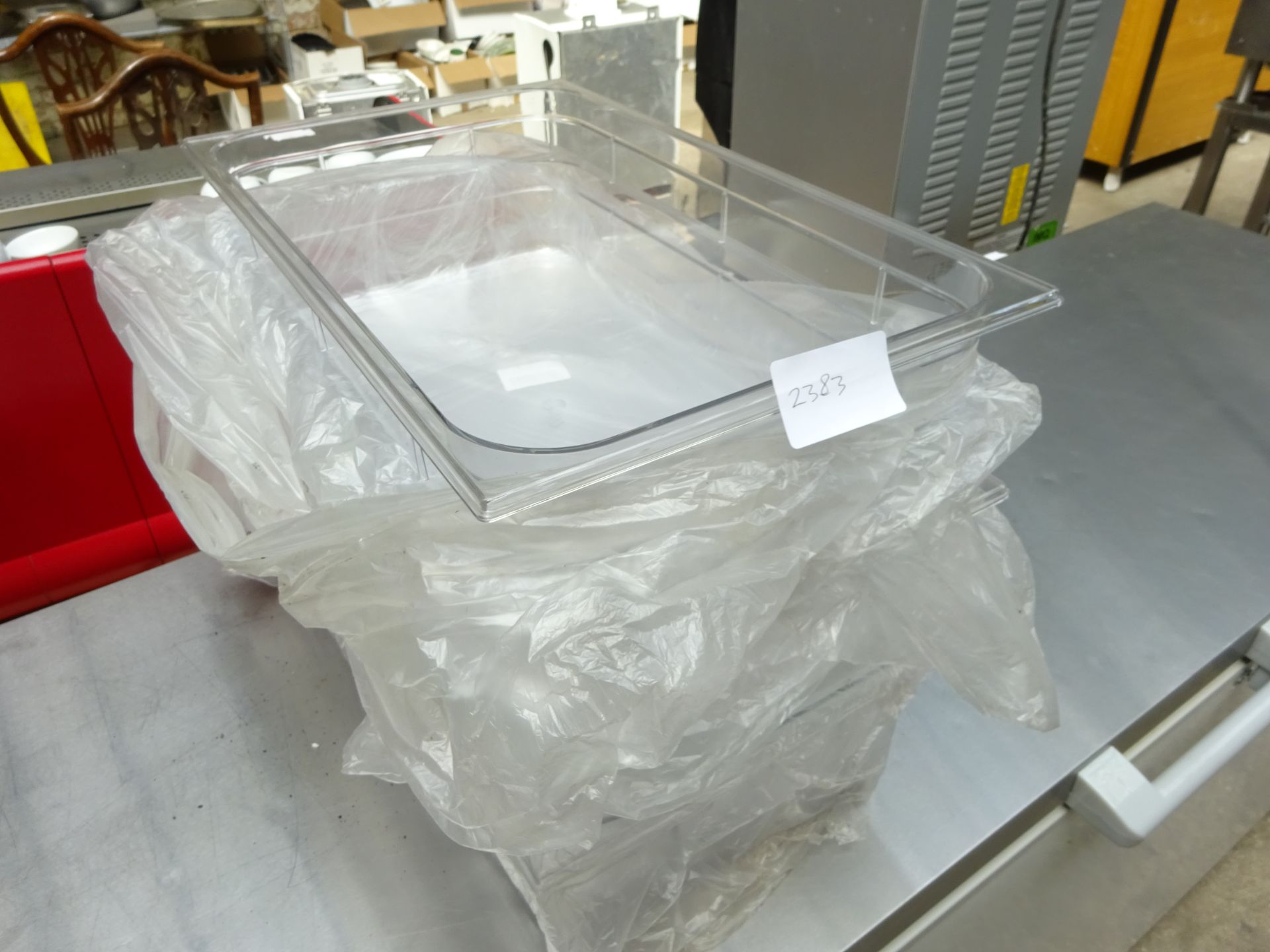 5 large clear plastic food containers.