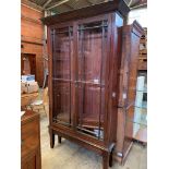 Large mahogany bookcase with 5 shelves and glazed doors, on legs.