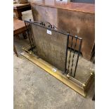 Wrought iron spark guard (length 91cms) together with a brass fender, 133 x 38cms.