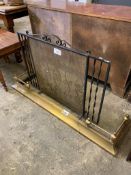 Wrought iron spark guard (length 91cms) together with a brass fender, 133 x 38cms.