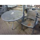 Outdoor metal round table with four chairs.