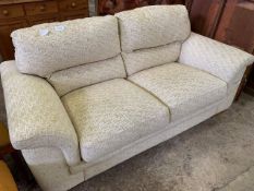 Beige upholstered 2 seat sofa.