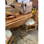 Circular drop-leaf pine kitchen table; 4 Windsor chairs; a circular utensil hanger and a pine cased