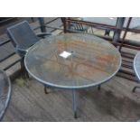 Outdoor metal round table with four chairs.