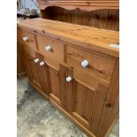 Pine dresser with white ceramic drawer knobs, 3 drawers over 3 cupboards.