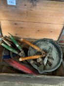 A pine box containing various garden hand tools.