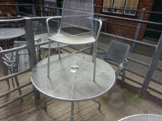 Outdoor metal round table with five chairs.