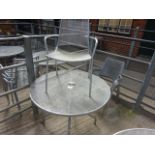 Outdoor metal round table with five chairs.