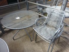 Outdoor metal round table with four chairs.