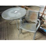 Outdoor metal round table with five chairs.