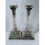 Victorian pair of Corinthian column silver plated candlesticks on cast bases. Height 28cms.