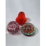 3 glass paperweights.