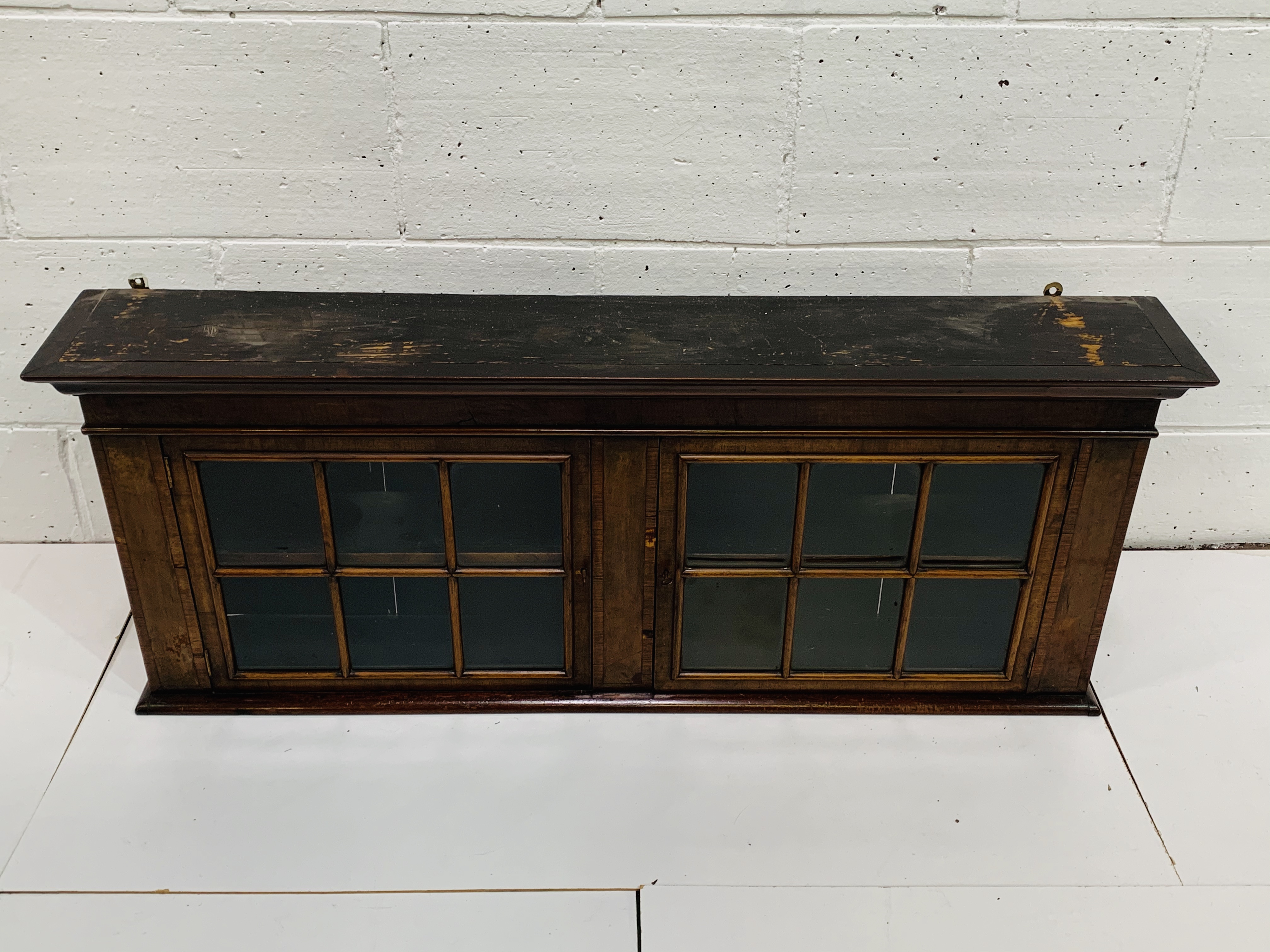 Mahogany wall mounted display cabinet with two shelves and two glazed doors.