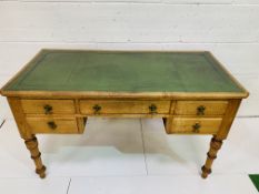 Oak Maple & Co desk with green leather skiver with three frieze drawers and two below