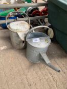 Two galvanised watering cans.