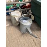 Two galvanised watering cans.