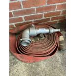 Reel of fire hose by George Angus & Co Ltd with aluminium nozzle.