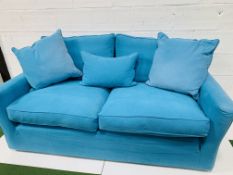 Two seat sofa by "Sofa Workshop" upholstered in turquoise cotton loose covers, with matching cushion