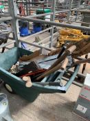 Plastic barrow containing shovels, picks, saws and galvanised gate furniture.