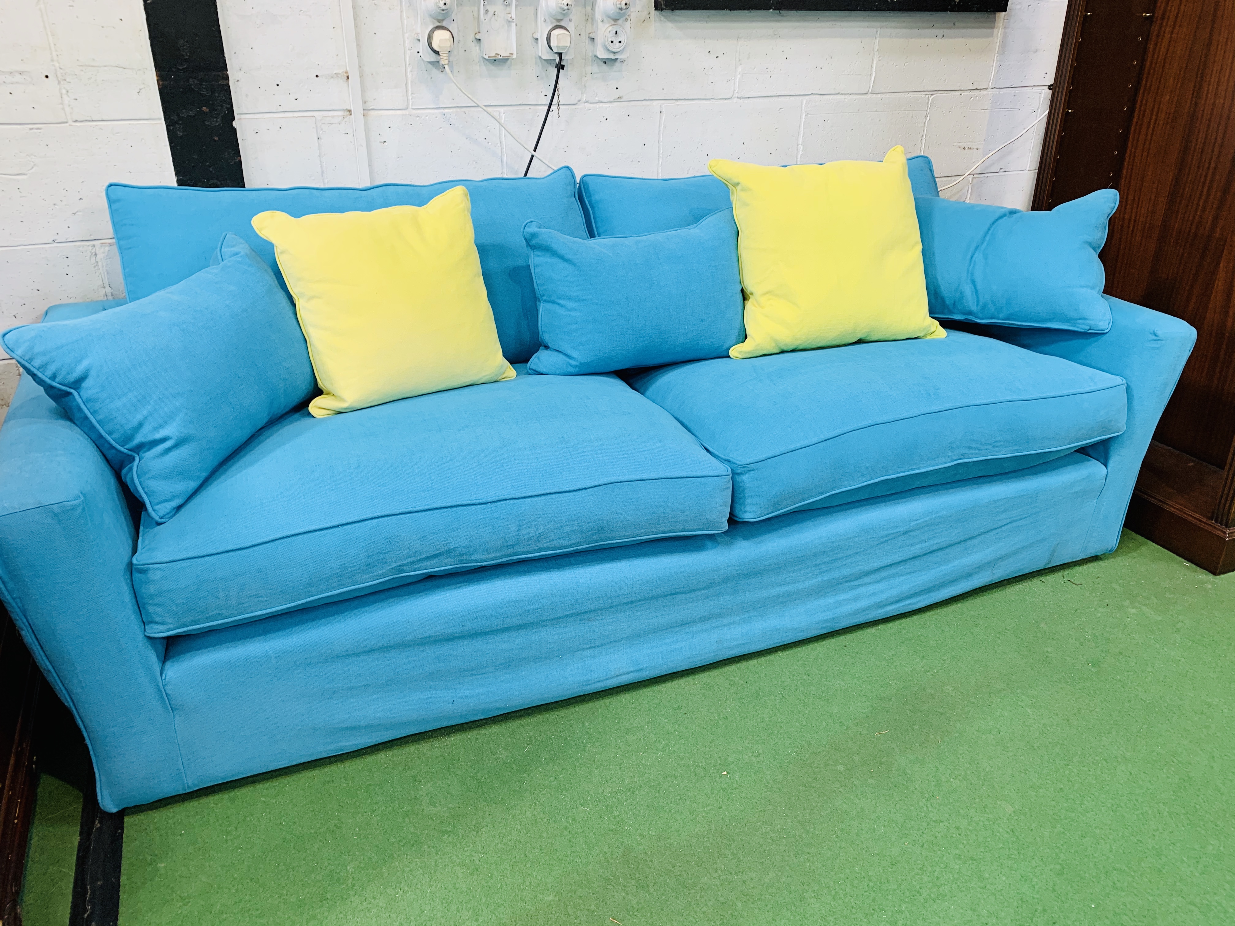 Three seat sofa by "Sofa Workshop" upholstered in turquoise cotton loose covers, with matching cushi