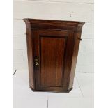 19th century oak wall mounted corner cabinet with three shape fronted shelves, complete with 2 keys.