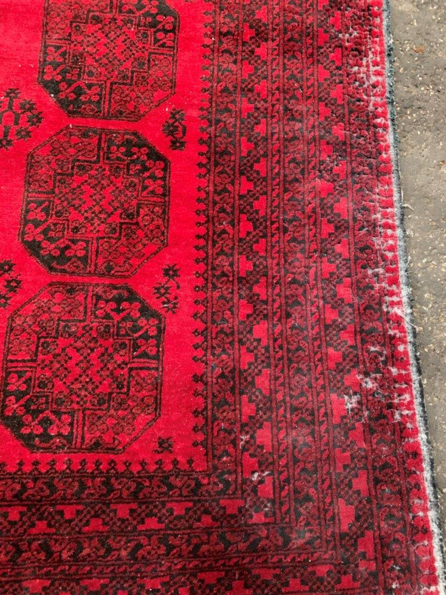 Wool pile red ground carpet rug made in Afghanistan. - Image 2 of 3