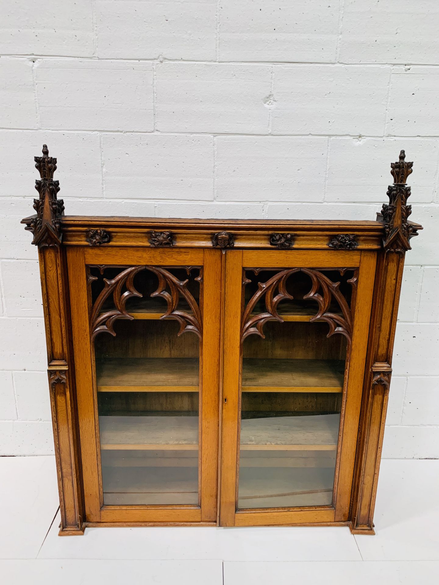 Victorian Gothic oak bookcase with glazed doors.