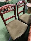 Four mahogany dining chairs with green upholstered seats.