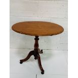 Mahogany oval tilt-top wine table.