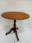 Mahogany oval tilt-top wine table.