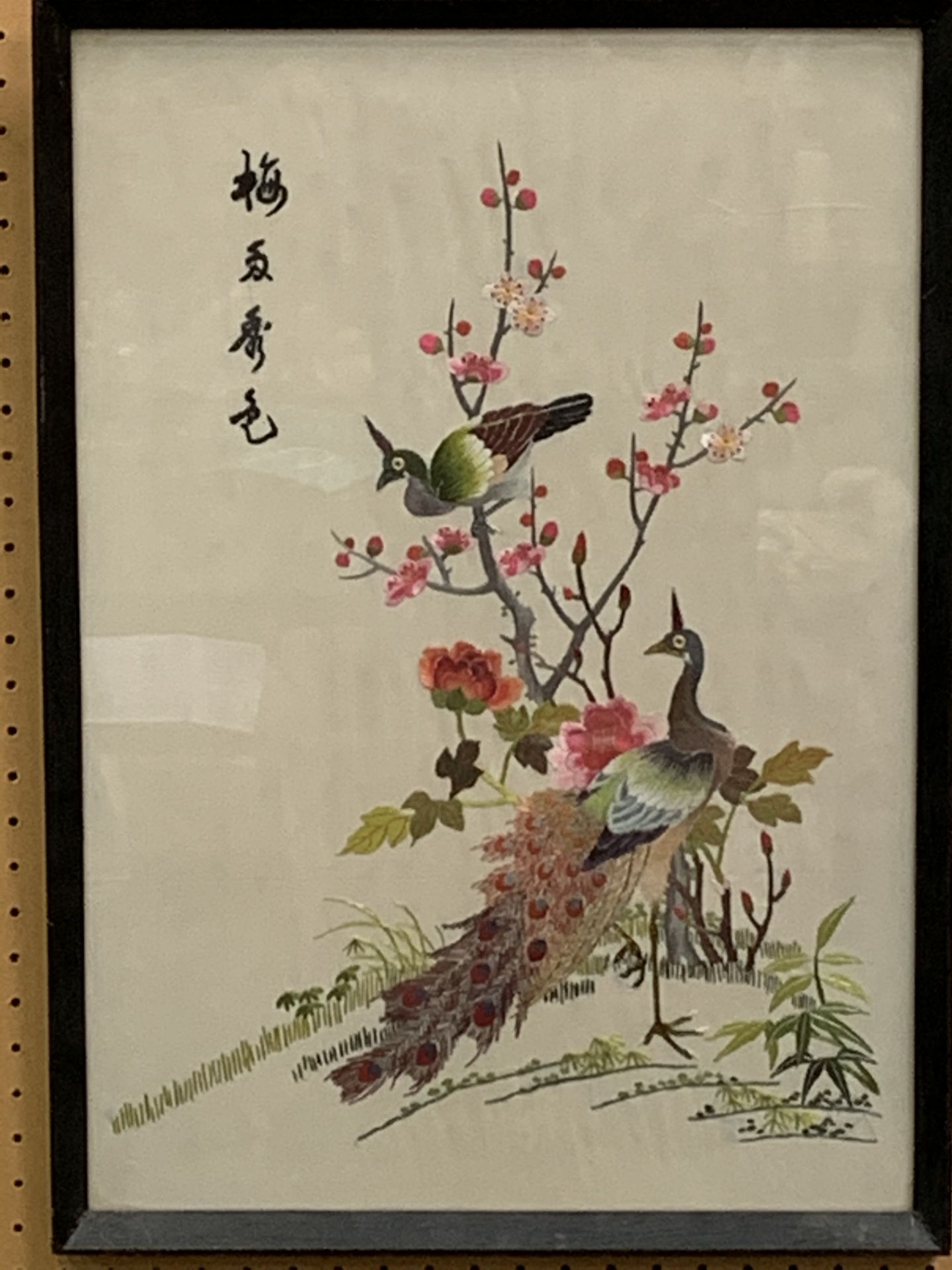 Framed and glazed Oriental embroidery on silk of peacocks and flowers.