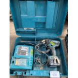 Makita BTP130 cordless drill with battery and charger in plastic case.