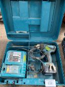 Makita BTP130 cordless drill with battery and charger in plastic case.