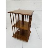 Mahogany revolving two tier bookcase on casters.
