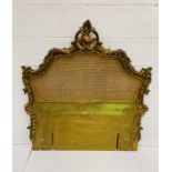 French headboard with cane panel and ornate gilt surround. 130 x 143cms.