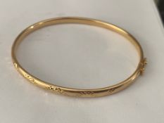 9ct yellow gold bangle with engraved design to top, 6gms.