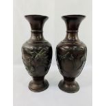 Pair of Meiji period bronze vases with etched and applied decoration to panels on both sides