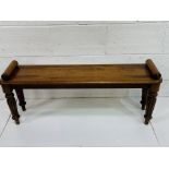 Mahogany hall bench with rolled ends on fluted legs.