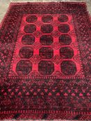 Wool pile red ground Afghan carpet.